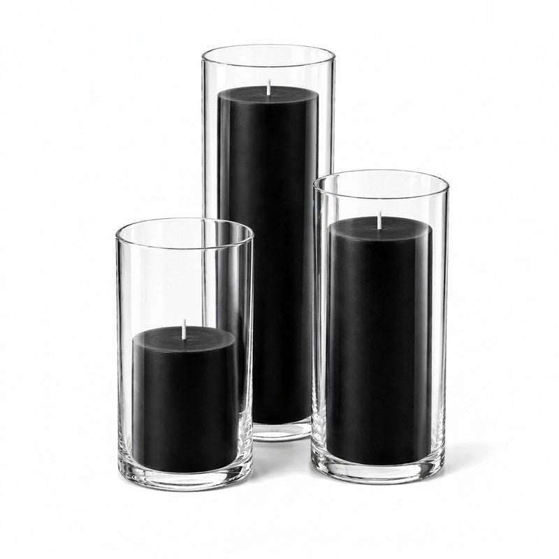 Three black pillar candles inside clear glass cylinder holders of varying heights - thumbnail number 1