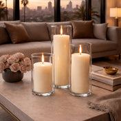 White pillar candles in clear glass vases on a stylish coffee table - thumbnail number 6