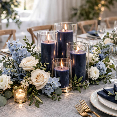 Navy pillar candles in glass vases on a romantic floral dining table - thumbnail number 3