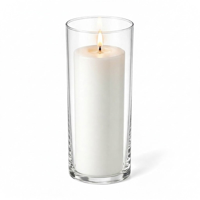 Lit white pillar candle inside a clear glass cylinder vase - thumbnail number 2