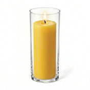 Lit yellow pillar candle displayed in a transparent glass holder - thumbnail number 2