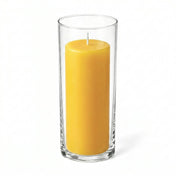 Tall yellow pillar candle displayed in a transparent glass holder - thumbnail number 1