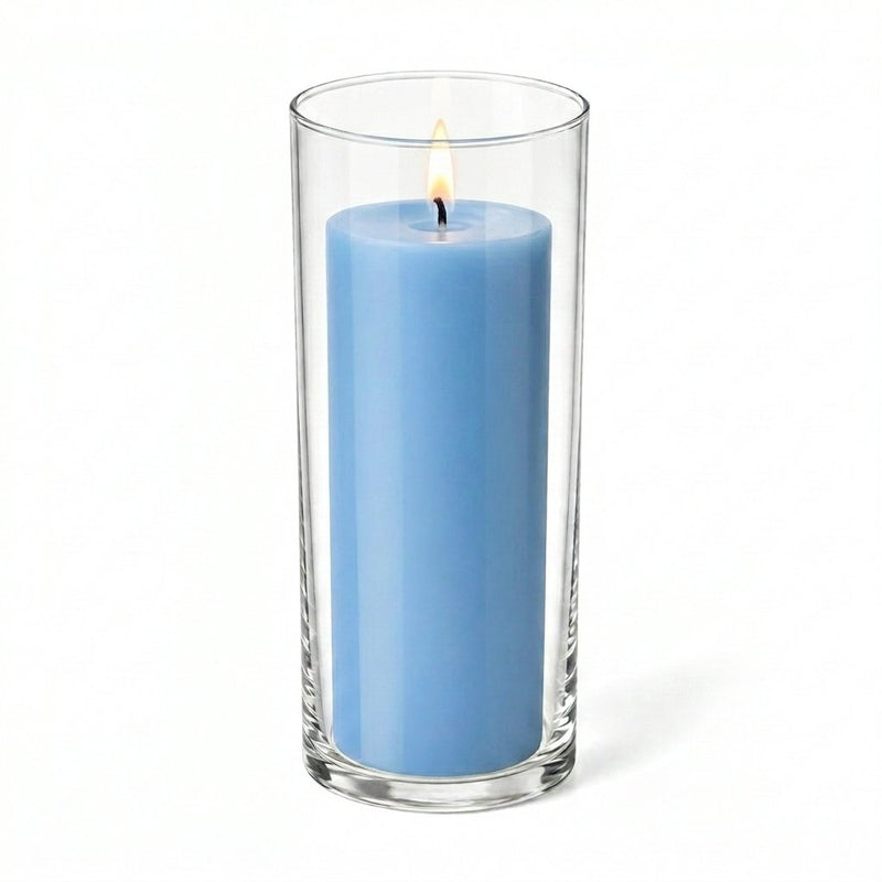Lit light blue pillar candle inside a clear glass cylinder vase - thumbnail number 2