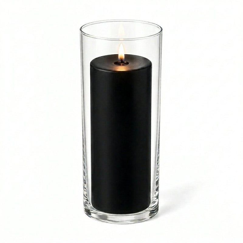 Lit black pillar candle inside a clear glass cylinder vase - thumbnail number 2