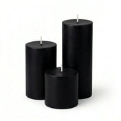 Three black candles of different sizes on a white background - thumbnail number 1
