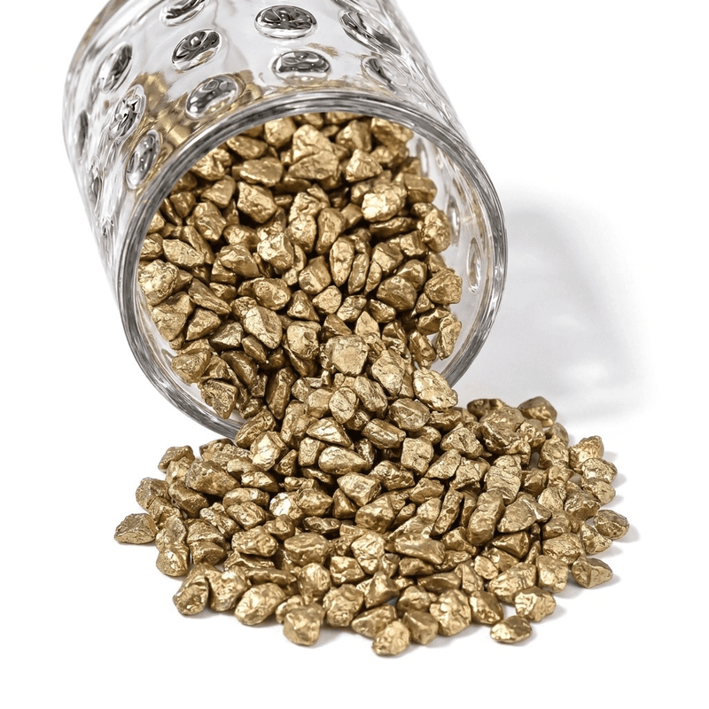 A glass jar spilling out small metallic gold stones for vase filler and decor - thumbnail number 1