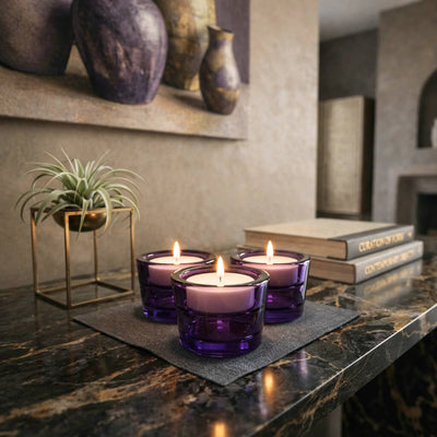 Three purple glass votive candle holders on a marble table - thumbnail number 9