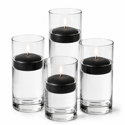 Four glass cylinders with water and lit black floating candles. - thumbnail number 1