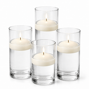 Tall glass cylinders filled with water and lit light ivory floating candles - thumbnail number 1