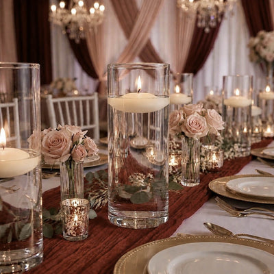 Lit floating candles in cylinder vases and pink roses on a wedding reception table - thumbnail number 5