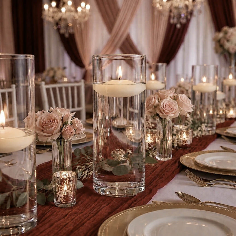 Lit floating candles in cylinder vases and pink roses on a wedding reception table - thumbnail number 5