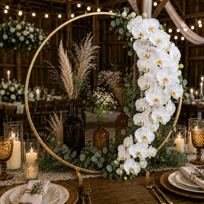 Gold hoop wedding centerpiece with white orchids and pampas grass on a rustic table - thumbnail number 5