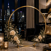Gold hoop centerpiece with beige roses and eucalyptus against a city skyline - thumbnail number 10