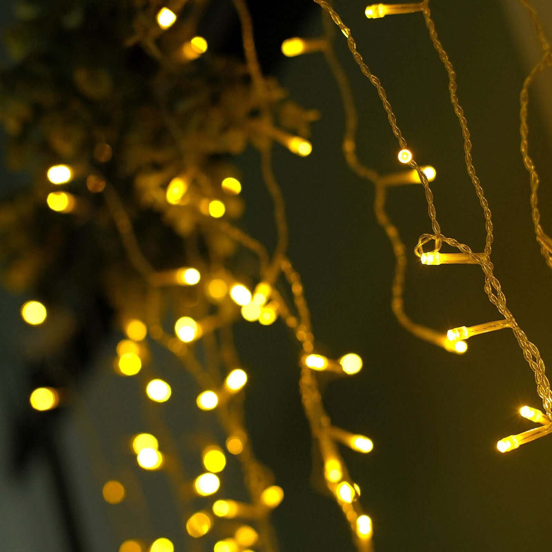 Warm yellow LED icicle lights hanging vertically with a soft bokeh background - thumbnail number 1