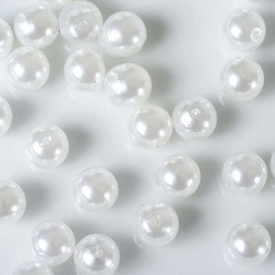Scattered glossy white faux pearl vase fillers on white backdrop - thumbnail number 1