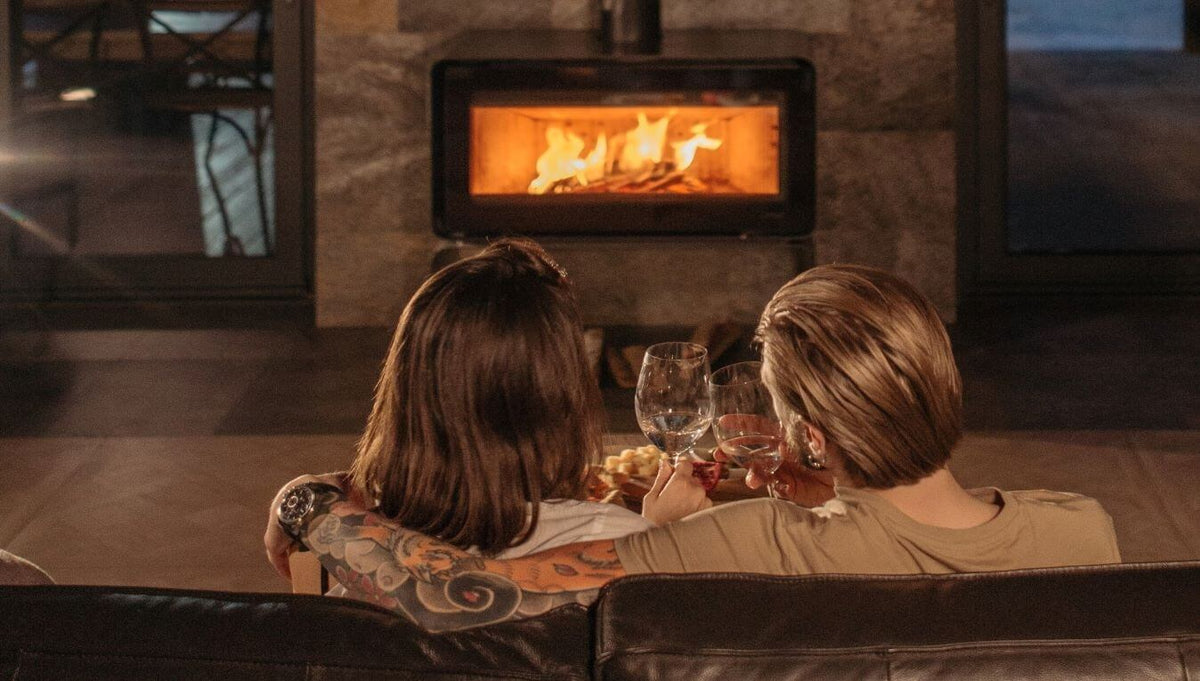 couple sitting in front of fireplace