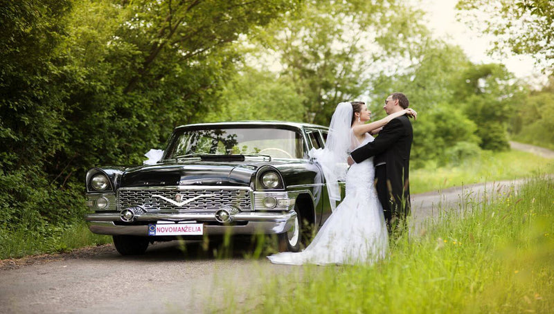 couple next to vintage car