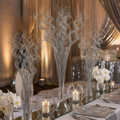 Silver sparkle curly ting stems in glass vases on a mirrored reception table - thumbnail number 2