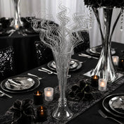 Silver sparkle curly ting stems in a glass vase on a formal black table setting - thumbnail number 7
