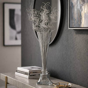 Silver sparkle curly ting stems in a tall glass vase on a console table - thumbnail number 8