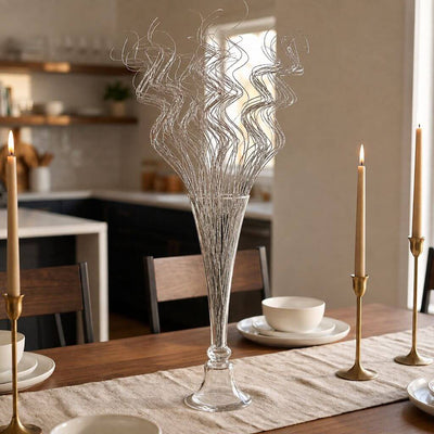 Silver sparkle curly ting stems in a glass vase on a dining table - thumbnail number 9