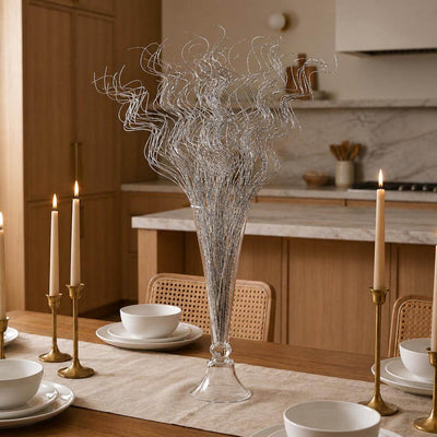 Silver sparkle curly ting stems in a glass vase on a wooden dining table - thumbnail number 10