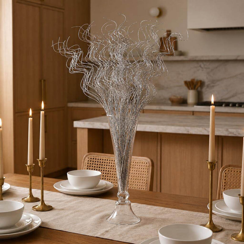Silver sparkle curly ting stems in a glass vase on a wooden dining table - thumbnail number 10