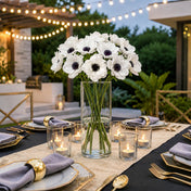 White anemone flowers in a glass cylinder vase on an outdoor dining table - thumbnail number 5