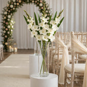 White gladiolus flower spray in a glass cylinder vase at a wedding - thumbnail number 3