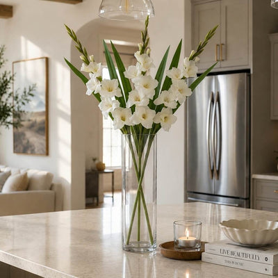 Alt text: White gladiolus flower spray in a glass cylinder vase on a kitchen counter - thumbnail number 7