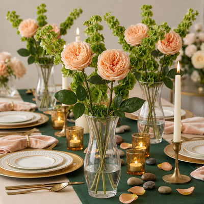 Long stem peach roses in a clear glass vase on a beautifully decorated dining table with candles - thumbnail number 3
