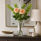 Long stem peach roses in a clear glass vase on a console table with a lamp and mirror - thumbnail number 6