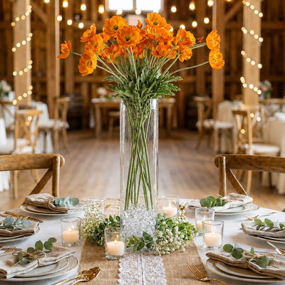 Orange poppy flower sprays in a tall glass vase as a centerpiece on a rustic banquet table - thumbnail number 4
