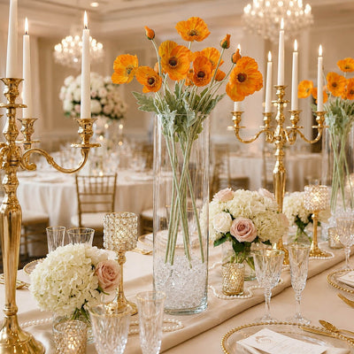 Orange poppy flower sprays in a tall glass vase on an elegant banquet table with candles - thumbnail number 5