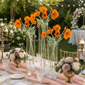 Orange poppy flower sprays in tall glass vases on an outdoor table - thumbnail number 6