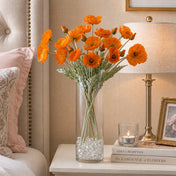 Orange poppy flower sprays in a tall glass vase on a nightstand - thumbnail number 7