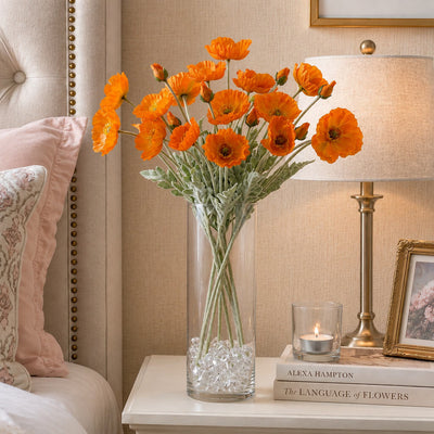 Orange poppy flower sprays in a tall glass vase on a nightstand - thumbnail number 7
