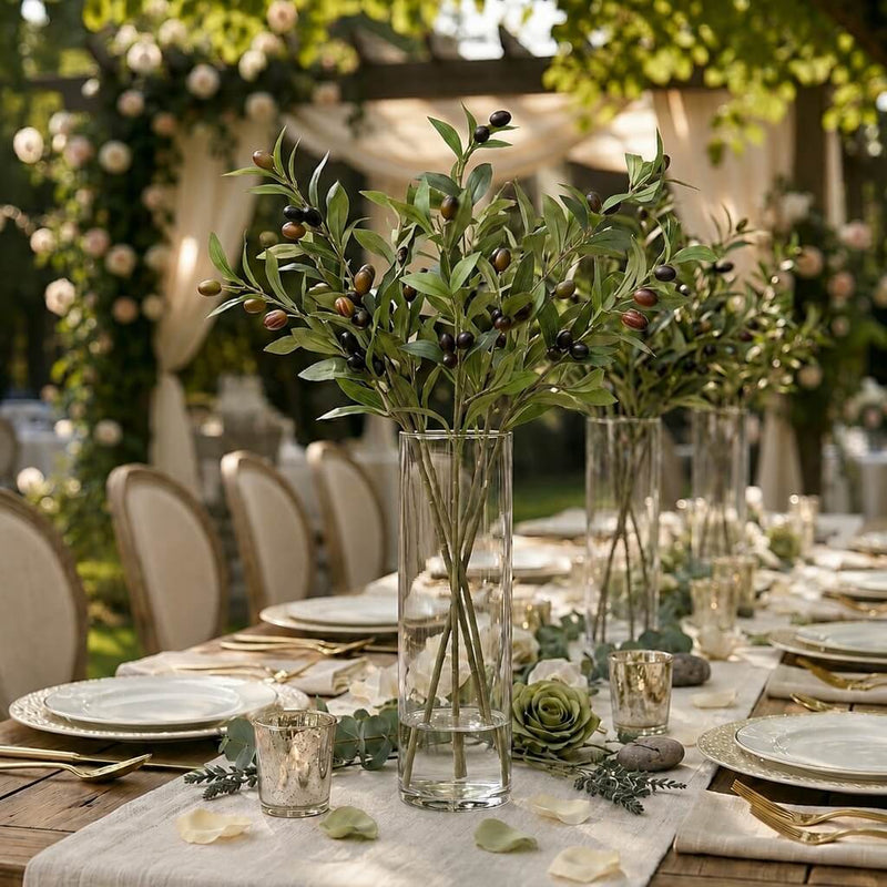 A tall glass vase of 31.5" olive branches on an outdoor wedding table - thumbnail number 3