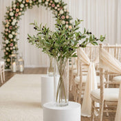 A tall glass vase of 31.5" olive branches on a pedestal for a wedding ceremony - thumbnail number 4