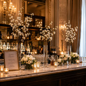 White cherry blossom branches in vases on a bar setup - thumbnail number 3