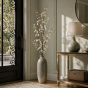 White cherry blossom branches in a tall ceramic vase in an entryway - thumbnail number 7