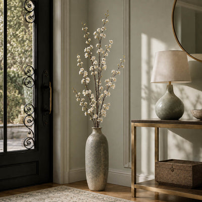White cherry blossom branches in a tall ceramic vase in an entryway - thumbnail number 7
