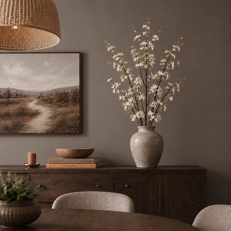 White cherry blossom branches in a ceramic vase on a sideboard - thumbnail number 8