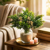 Green boxwood sprays with small white flowers in a glass vase with sand - thumbnail number 9