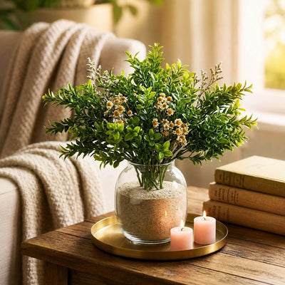 Green boxwood sprays with small white flowers in a glass vase with sand - thumbnail number 9