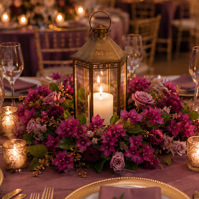 Bougainvillea and rose floral wreath surrounding a lit lantern on a table - thumbnail number 7