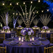 Pussy willow branches and purple flowers decorate tables at an outdoor nighttime reception - thumbnail number 3