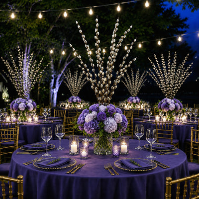 Pussy willow branches and purple flowers decorate tables at an outdoor nighttime reception - thumbnail number 3