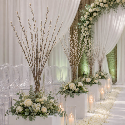 Pussy willow branches and white floral arrangements line a wedding aisle - thumbnail number 5