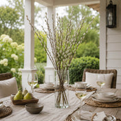 Pussy willow branches in a tall glass vase on an outdoor dining table - thumbnail number 7